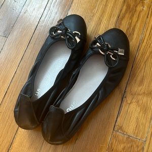 Black flats with gold accents